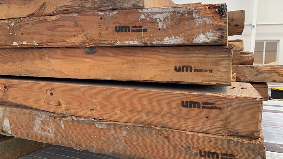 Urban Machine "UM" branded reclaimed wood beams